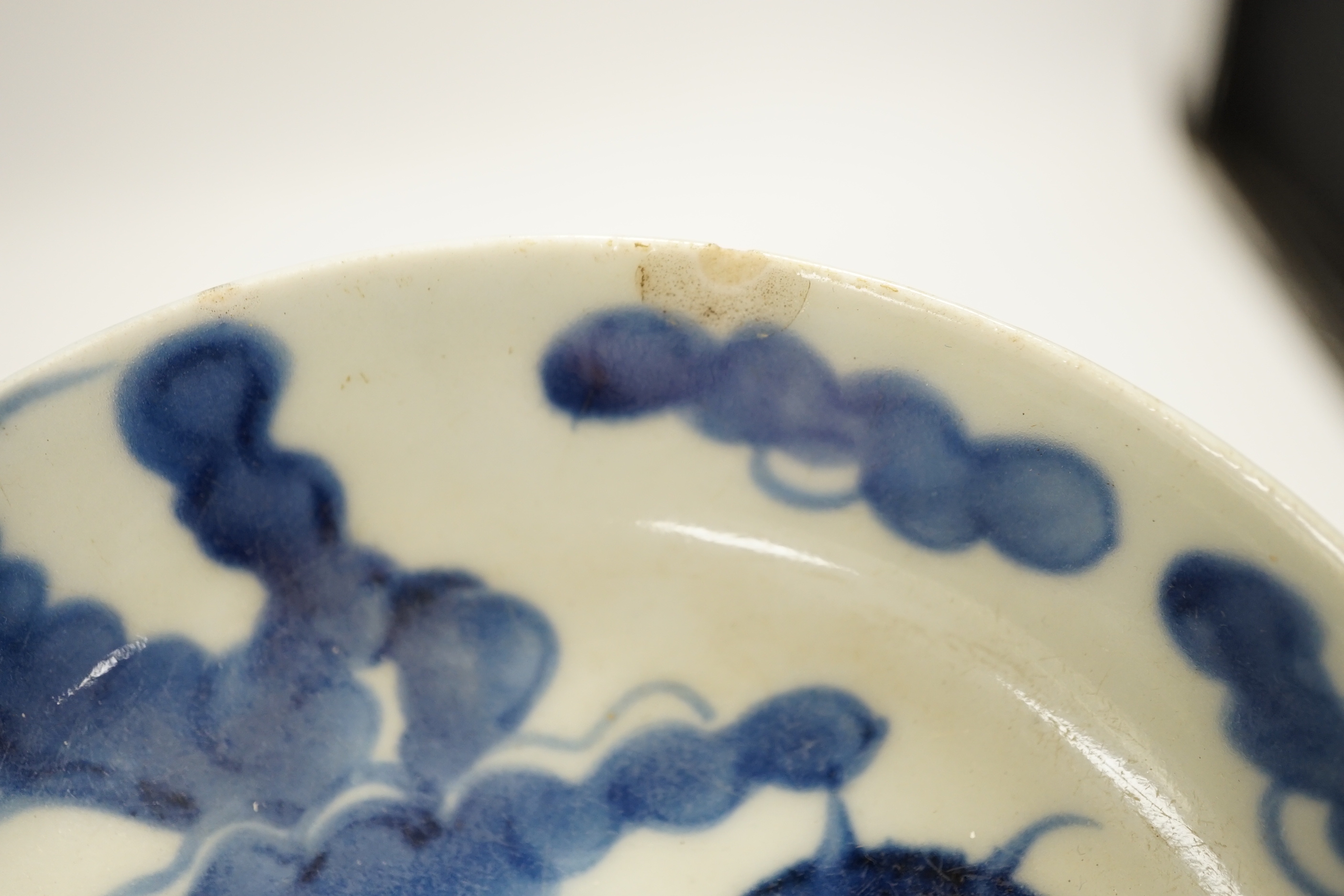 An 18th century Chinese export blue and white dish together with two others, largest 26cm